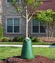 Treegator® Original single bag filled on tree on top of mulch next to curled water hose