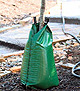 Treegator® Original single bag shown on tree trunk planting on top of dark mulch